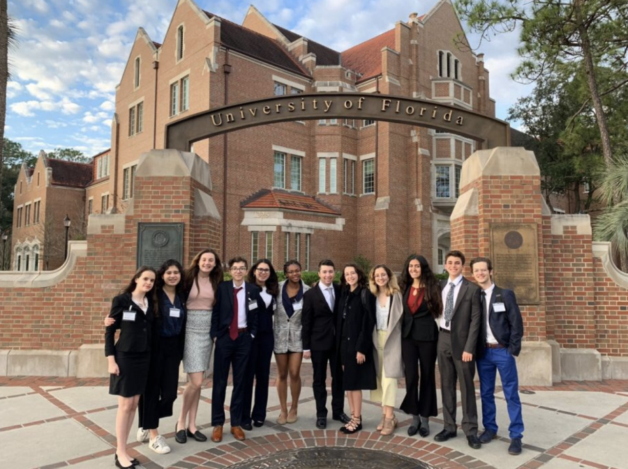 Gables+students+pose+for+a+picture+in+front+of+the+UF+sign+before+conference%2C+as+per+tradition.