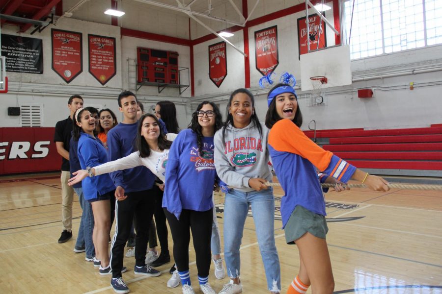 Seniors smile while playing a game of tug of war. 