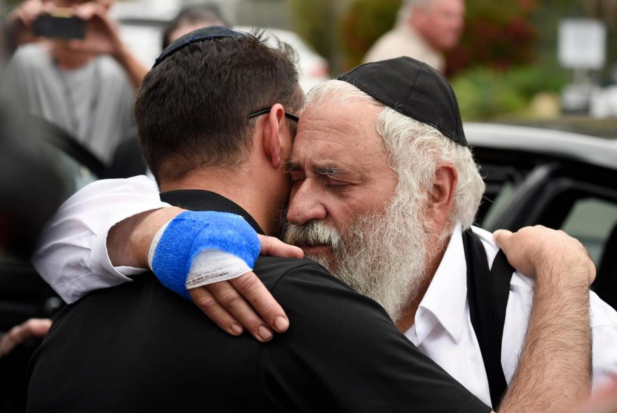 The injured Rabbi embraces another deeply saddened member of his community.