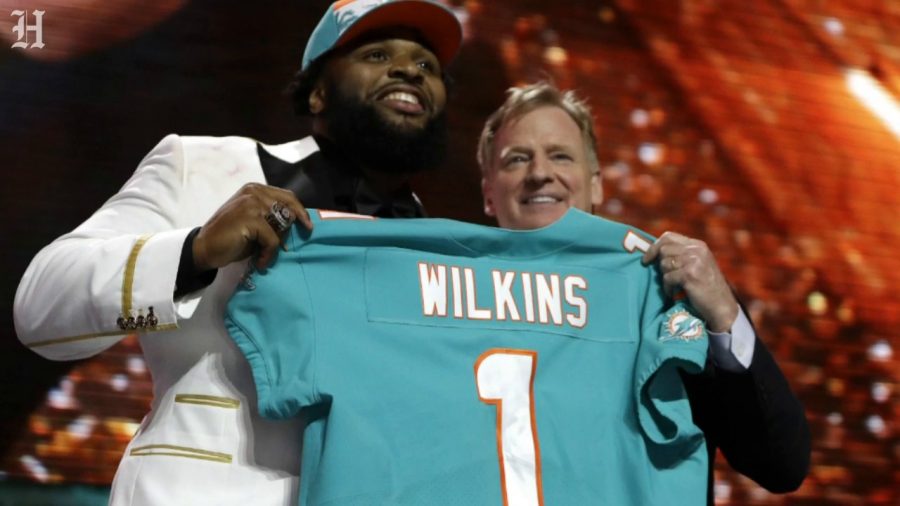 NFL+Commissioner+Roger+Goodell+presents+the+number+13+overall+pick%2C+Christian+Wilkins%2C+with+his+Miami+Dolphins+jersey.