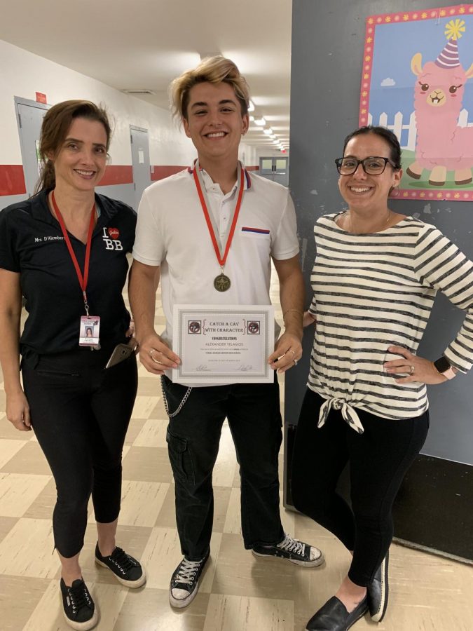 Senior Alex Yelamos stands with Mrs. D'Alamberte and Mrs. Camacho. 