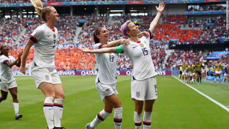 Megan+Rapinoe+triumphantly+celebrates+with+her+teammates+after+scoring+a+goal+in+the+2019+Womens+World+Cup.+