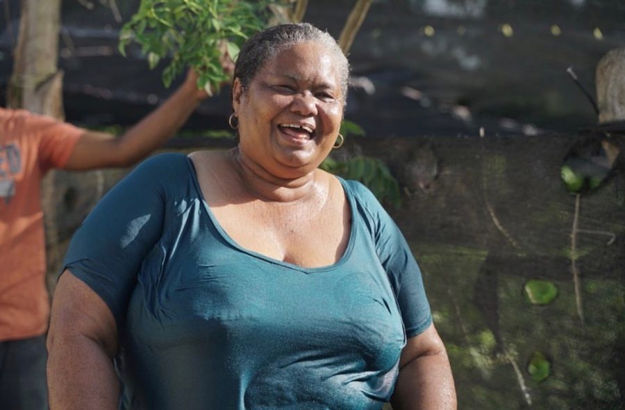 A smiling Dominican woman on water day.
