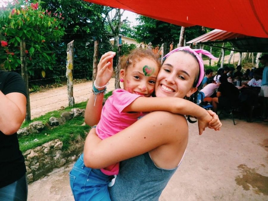 Alexandra Torres embraces and carries her new friend in the Dominican Republic.