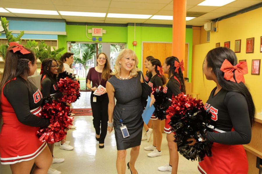 School board member, Mari Tere Rojas eagerly greets students as she walks into the media center.