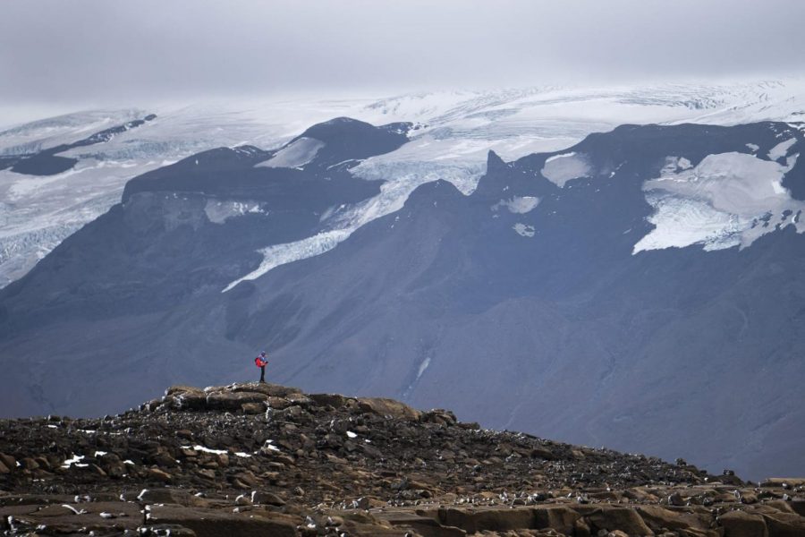A man participating in the memorial for the Okjökull glacier looks out into the distance, standing where the glacier once lied.