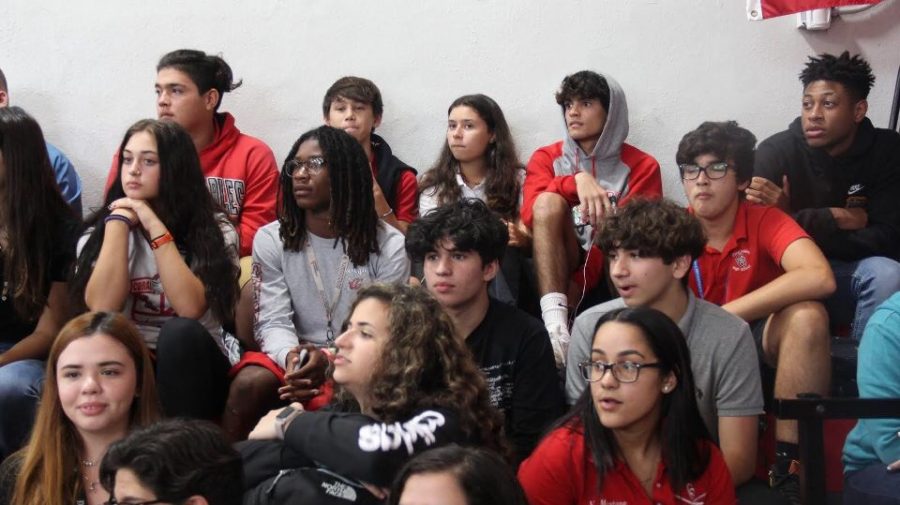 The audience watching the performers closely.