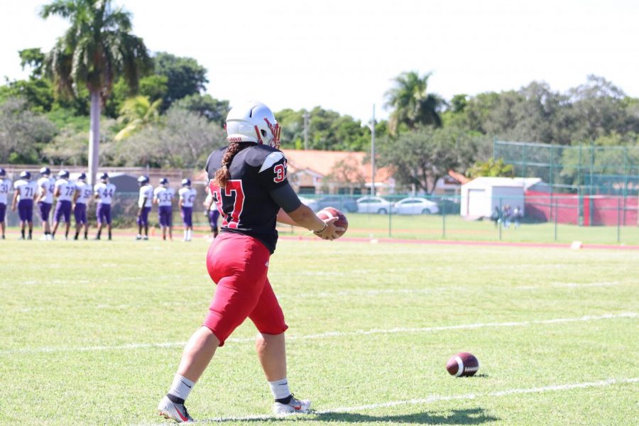 Sophomore kicker Arianna Gonzalez readies to kick a punt during a pre-game practice.