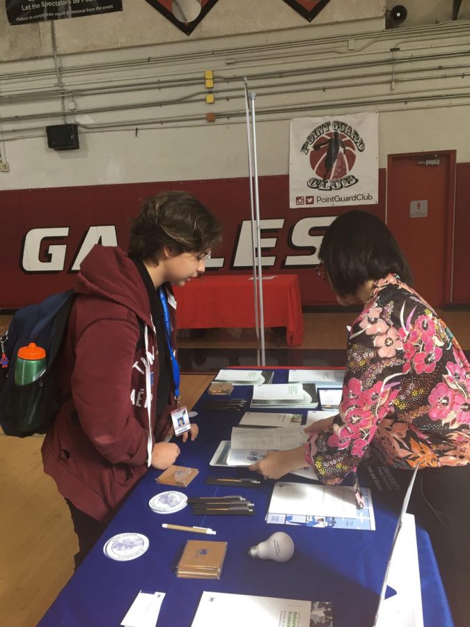 A cavalier student converses with a representative from IE University during the on-campus college fair Oct. 11.