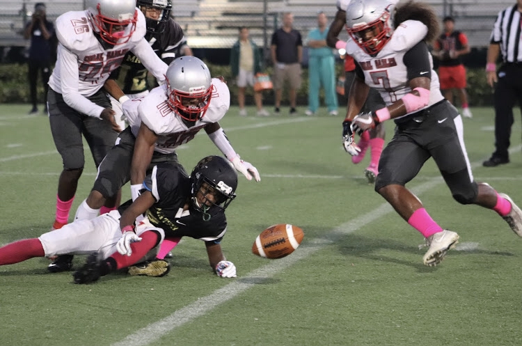 The Cavalier Football defense scrambles for the loose football during a game Mater Academy Charter school. 