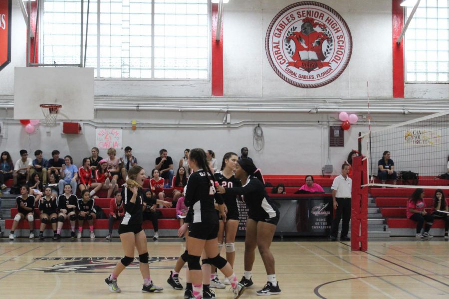 Lady Cavaliers celebrate in a huddle after scoring against the Makos.