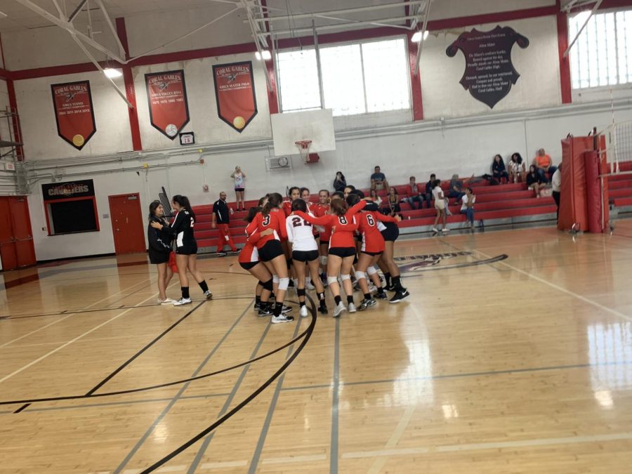 The Lady Cavalier Volleyball team huddles to lift their spirits and discuss their game plan.