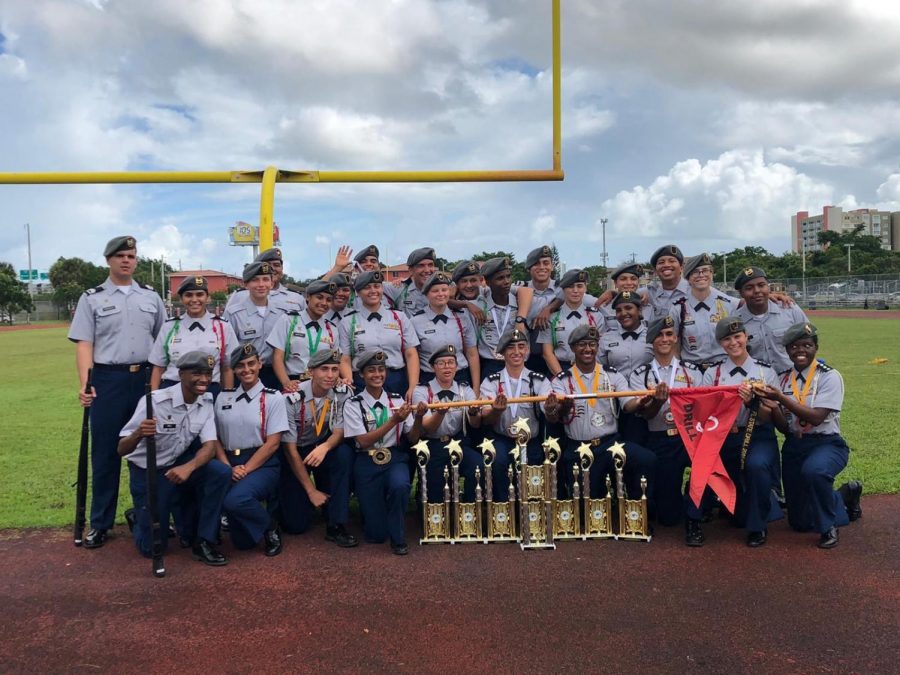 Junior Reserve Officers Training Corps pose with the trophies they won from their drill competition. 