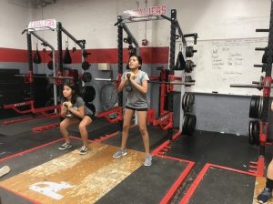 The Lady Cavaliers condition in the Cavalier weight room, performing strength training in preparation for the upcoming winter soccer season.