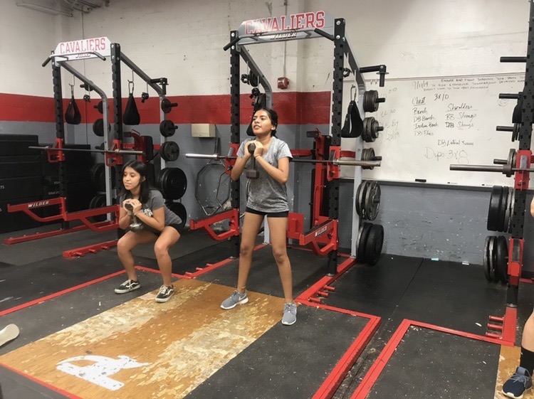 The Lady Cavaliers condition in the Cavalier weight room, performing strength training in preparation for the upcoming winter soccer season.