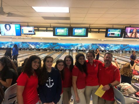 The Coral Gables Lady Cavalier Bowling team poses for a team picture with coach Campagna.