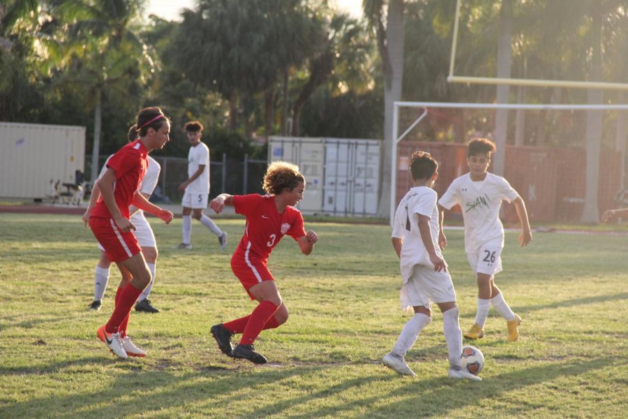 The Coral Gables Cavaliers fighting to regain possession of the soccer ball from SLAM, where the Cavaliers showed their offensive prowess with a 5-1 victory.