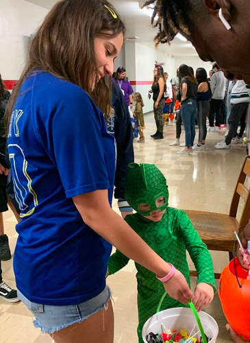 Child Care student Trick or Treating in the school´s halls.