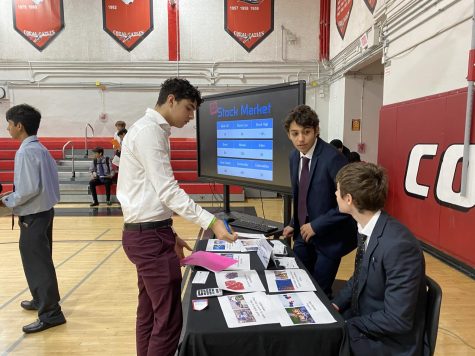 A student examines his options for investing in the mock stock market during the 2019 Mad City Money event.