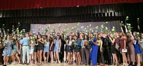 Several proud juniors show off their roses and pins in celebration.