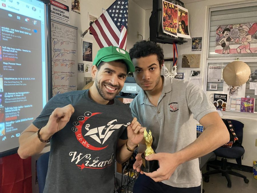 Kevin Mojarrez posing with this championship trophy after winning the CGSH Smash Invitational with Mr. De Armas