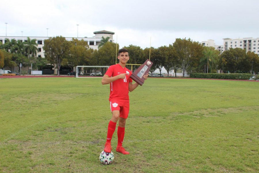 Julio Villamar poses with the championship trophy