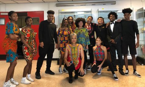 students who participated in the show gathered around Ms. Brown in front of the auditorium.