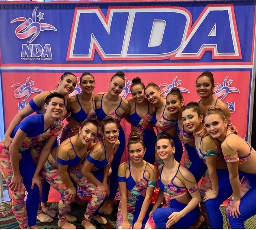 The Gablettes posed for a picture in their colorful kick costumes waiting to take the stage. 