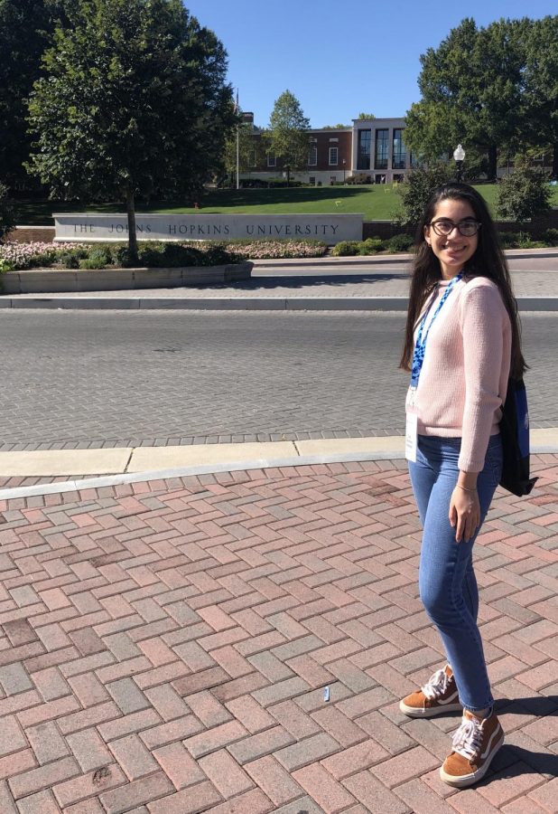 Senior Lia Sanchez standing in front of her dream college, to which she has recently committed to.
