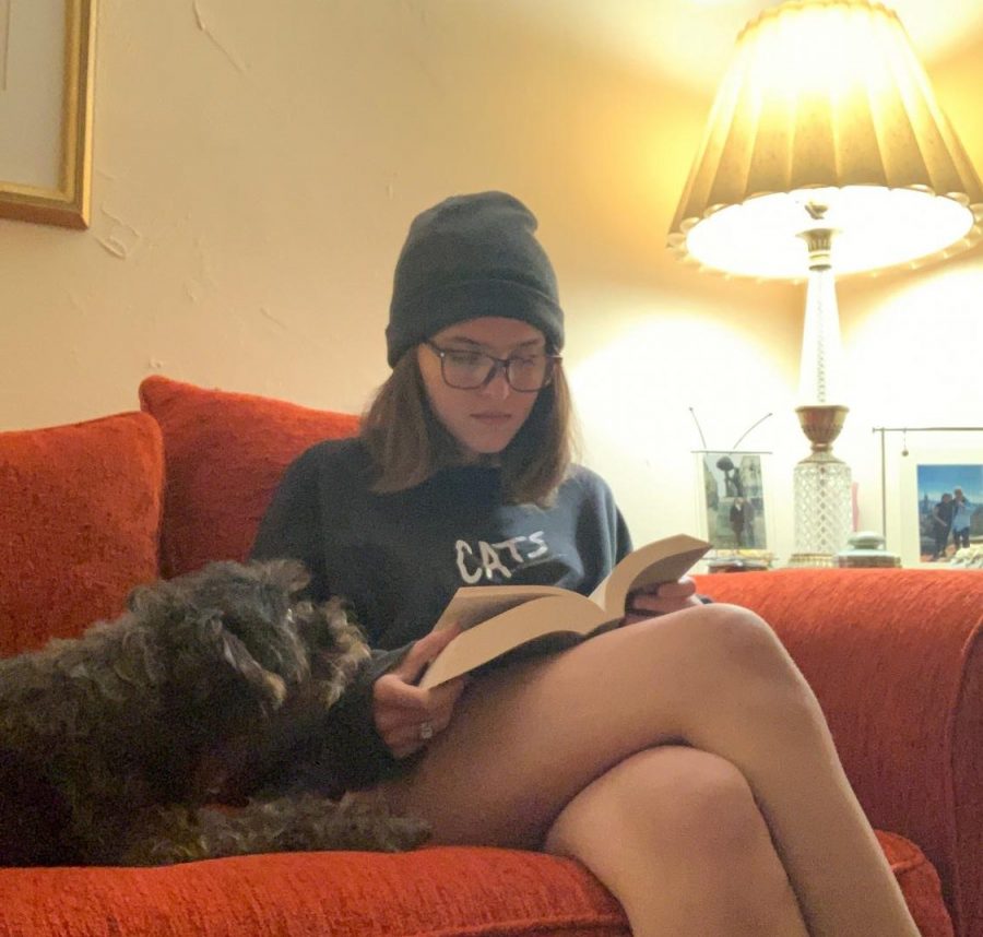 Senior Lia Rodriguez reads The Women in White by Wilkie Collins with her dog. 
