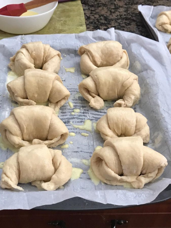 Croissants when they are finished being rolled into their crescent shape.