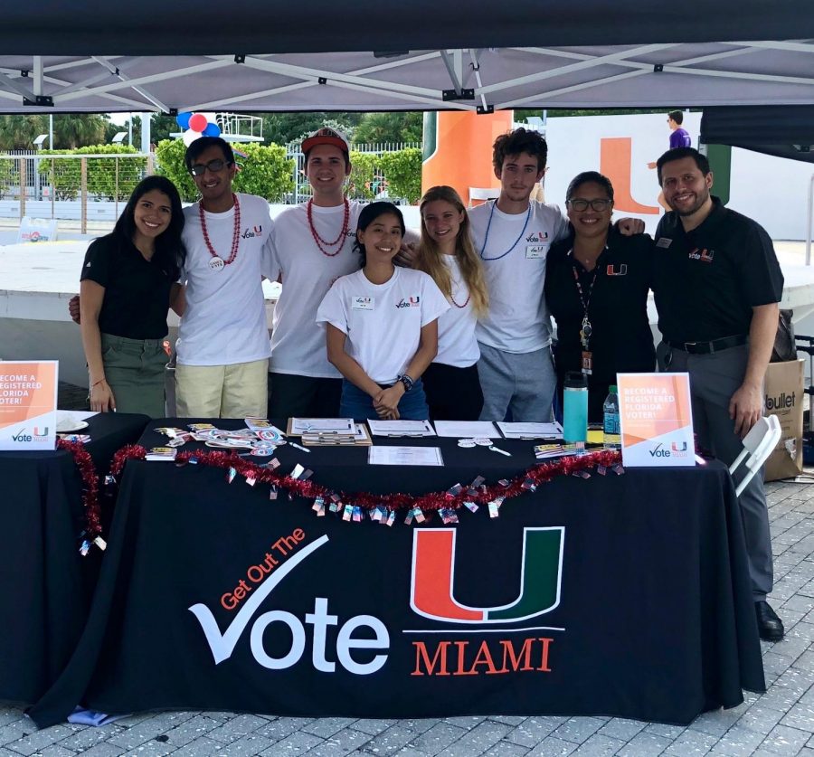 Alumni Albany Muria (far left) with some classmates and administrators, on the National Voter Registration Day.