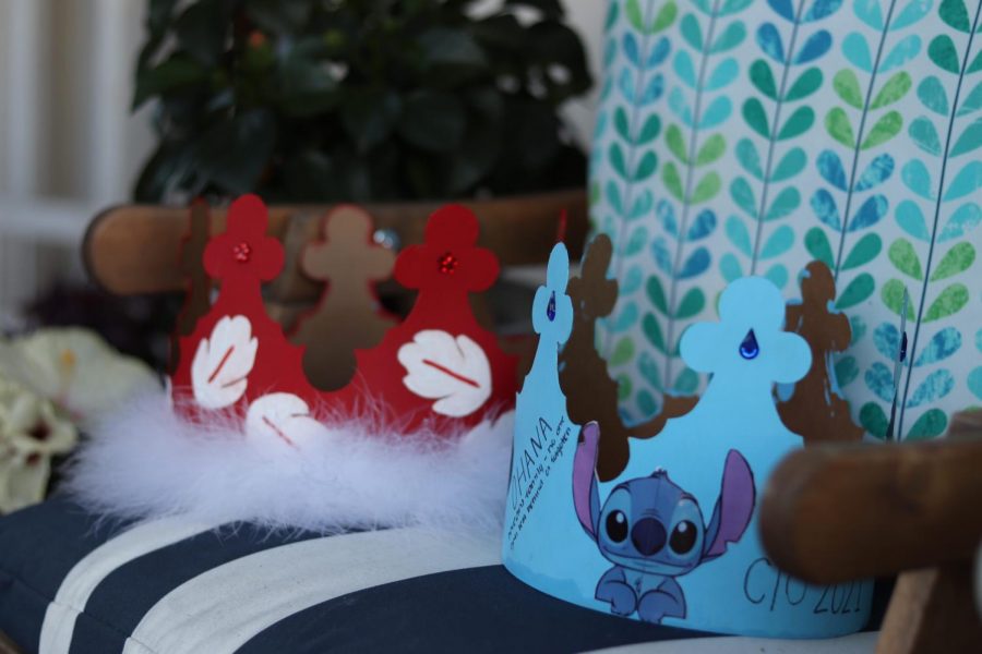 The crown to the left is based off of Lilo, because of its red color, white leaves and the fluffy border. The crown to the right is based off of Stitch, because of the drawing of Stitch on it and its blue color. 