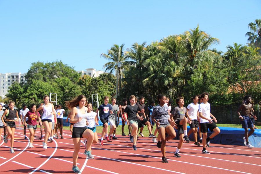 The 2019-2020 Gables track team warms up after school on the track for practice before coronavirus forced them to end their season early.