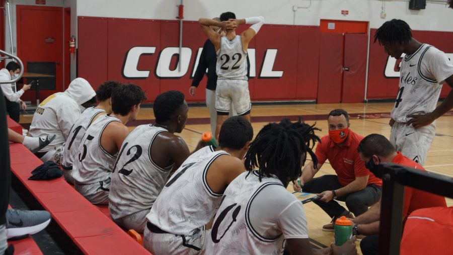 Coach Govea goes over a game plan with his team.