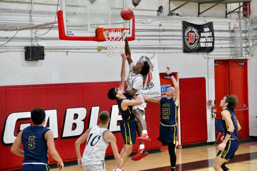 Varsity player, Jonathan Similien attacking the basket.