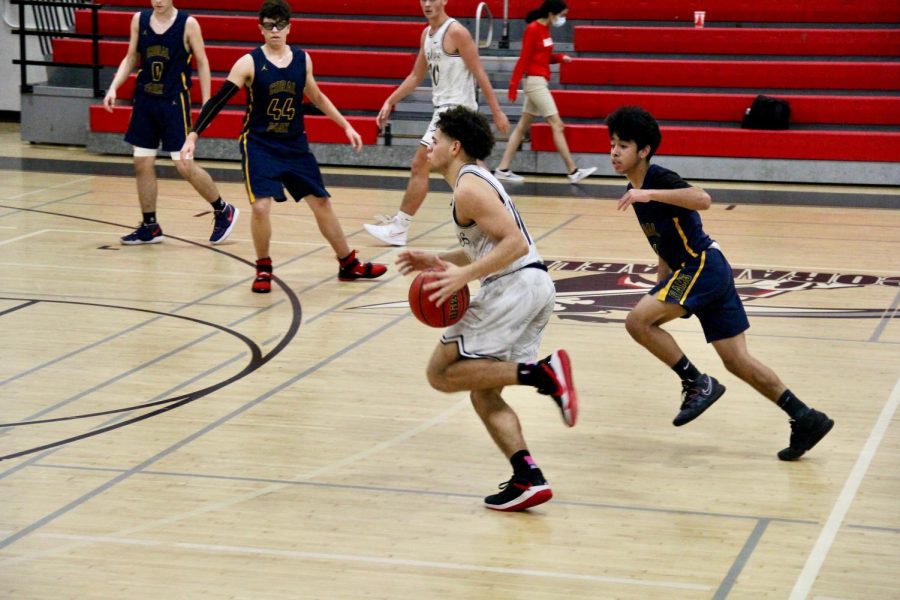 Varsity player, Marcos Molina looks to set up a play for the Cavaliers.