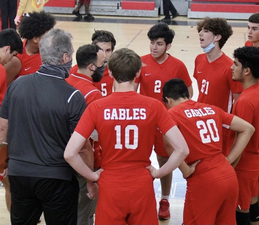 The Cavalier volleyball team in a team huddle in the midst of a game against Westland.