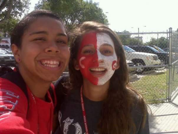 A student with spirit, Lazaro paints her face with Gables colors during the schools Spirit Week.