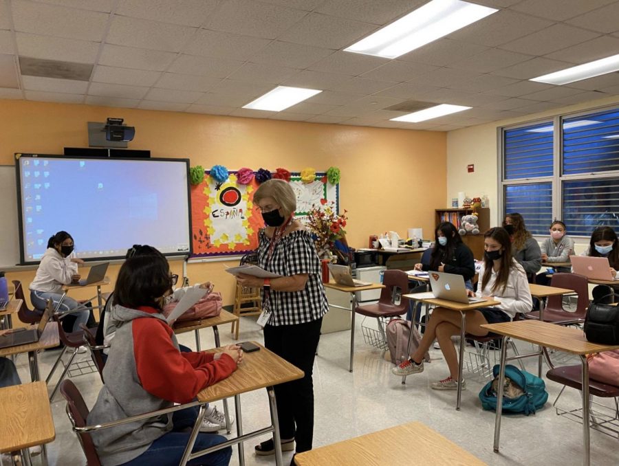 After carefully reviewing and grading the first essay exam of the school year, Mrs. Haun is pictured returning them to her students so they could understand the grade they earned.