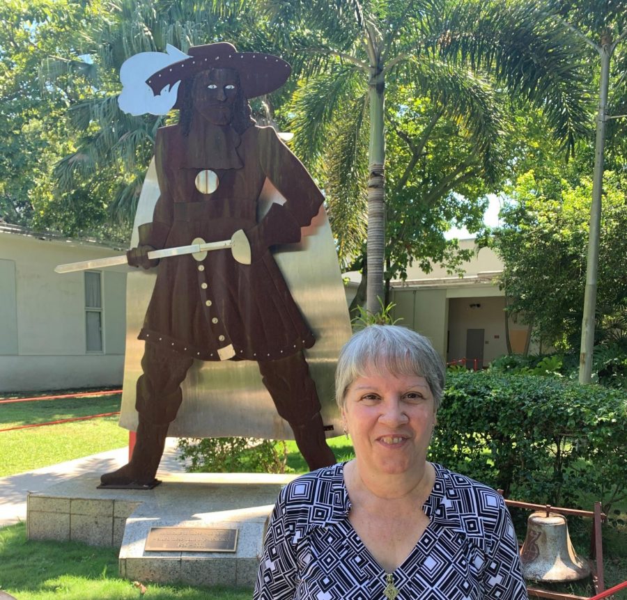 After working at Gables as the IB Secretary for 37 years, Ms. Bello proudly stands next to the Gables Cavalier as she enjoys her final school year.