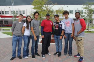 The Chess Club board members, Adrian Gonzalez, Maria Montelongo, Diego Gomez, Massimo Aguila, Ruben Cruz and Edghlys Lopez (left to right) pose alongside Mr. Sanchez for their first yearbook picture.