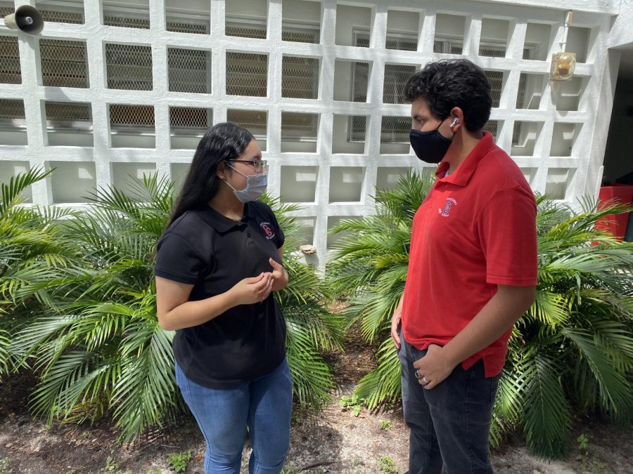 Seniors Lenny Roque (right) and Isabella Flores (left) talking about the new uniform policy being implemented in the school