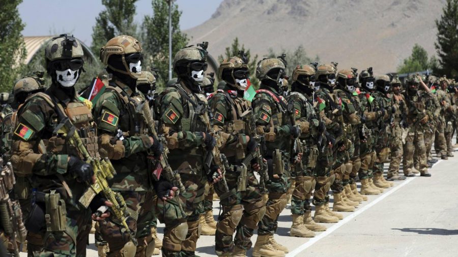 The Afghanistan army lining up, wearing protective masks and carrying guns. Courtesy of The Institute of International Affairs.