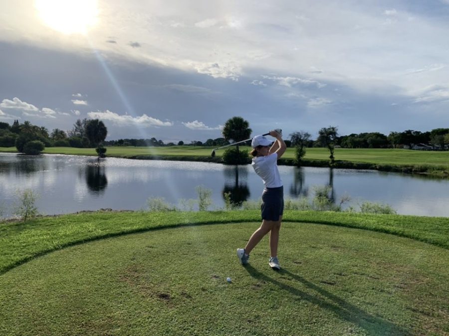 Lady Cavaliers take practice shots before a par three hole during their match against Southwest High at the Miccosukee Golf & Country Club.