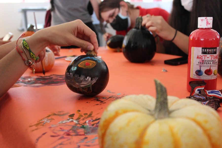 Senior Esperanza Barrios adds finishing touches to her pumpkin portrait.