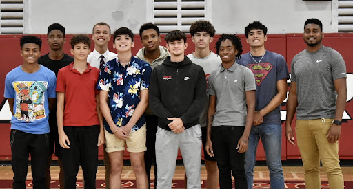 Although they just met, the boys basketball team stands alongside Coach Shoon, already fostering the team bonding that is needed to win this season.