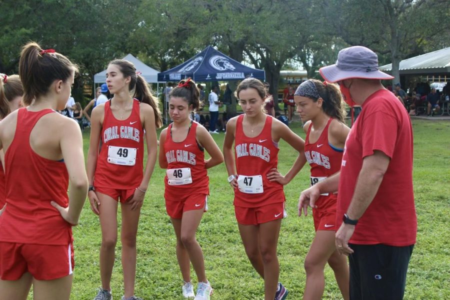 Head coach of the girls team, Scott Nelson, gives his athletes a pep talk before the race begins.