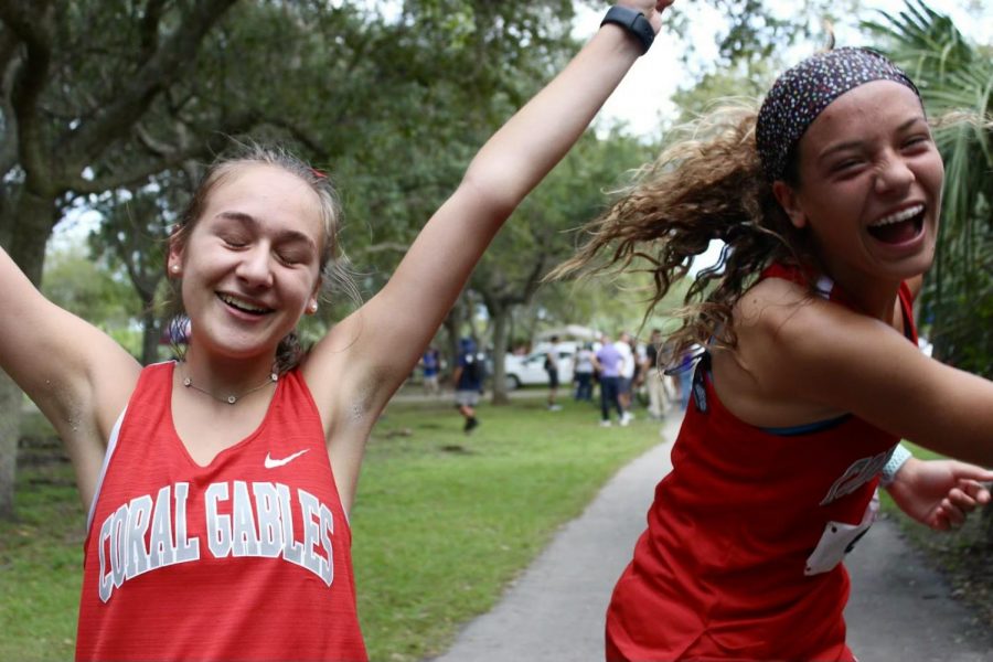 Runners Catalina Quinteros and Audrey Simon celebrate their achievement at regionals.