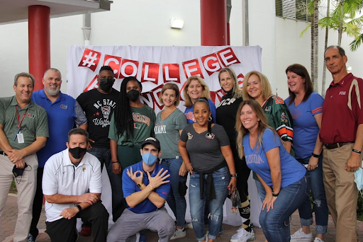 Decked out with college spirit, the Social Studies department gathered together at the photo booth after winning lunch with the principal.